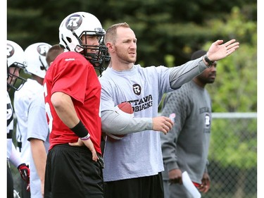 Corey Leonard (R) talks to Jesse Mills during the opening day for the RedBlacks rookies training camp, May 28, 2014.