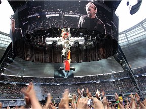 The crowd waves at U2's Bono during a performance at the Stade de France stadium in a Paris suburb, during a concert of the U2 360 Degrees world tour. Here are some of the tours Arthur Fogel has worked on.