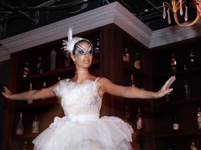 Dancer Julia Gatto performs ballet on the bar during the opening night VIP party for the Moscow Tea Room.