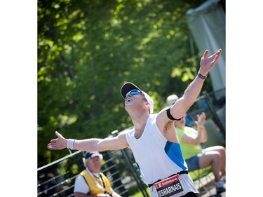 Daniel Desharnais holds his hands out after finishing the marathon at Ottawa Race Weekend Sunday May 25, 2014.