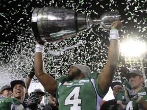 Saskatchewan Roughriders quarterback Darian Durant hoists the cup after beating the Hamilton Tiger-Cats in the Grey Cup, Sunday, November 24, 2013 in Regina.