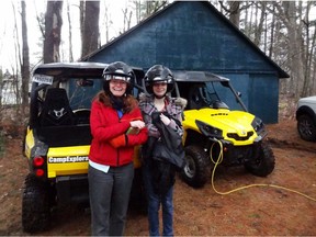 Laura and Stephanie Paquet model their helmets after their ATV adventure.  
Remi Tremblay photo.
