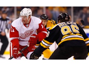 BOSTON, MA - APRIL 20: Daniel Alfredsson #11 of the Detroit Red Wings carries the puck down the ice in front of Kevan Miller #86 of the Boston Bruins in the second period during the game at TD Garden on April 20, 2014 in Boston, Massachusetts.