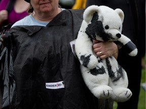 A protester holds a stuffed polar bear painted black to simulate oil during a protest against the Enbridge Northern Gateway Pipeline in Vancouver earlier this month.