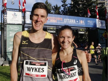 Dylan Wykes, the top Canadian male finisher, and Lanni Marchant, the top Canadian female finisher, pose for a photo at the finish line at the 10k race during the Ottawa Race Weekend on Saturday May 24, 2014. (Patrick Doyle / Ottawa Citizen)  ORG XMIT: 0526 ottawa10k31