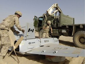 English/Anglais�br&ampgt; IS2006-0280�br&ampgt; 6 July 2006�br&ampgt; Kandahar Airfield, Afghanistan�br&ampgt;�br&ampgt;  Master Bombardier (MBdr) Patrick Moreau (left) and Bombardier (Bdr) Steve Michaud-H�bert recover the Unmanned Aerial Vehicle (UAV) after descending from an early mission July 6 2006 at Kandahar Airfield, Afghanistan. �br&ampgt;�br&ampgt;  MBdr Moreau and Bdr Michaud-H�bert are part of the 5e R�giment d�artillerie L�g�re Du Canada, from Valcartier, Quebec, which operates the UAV that is instrumental in providing valuable information to the Commanders and troops on the ground. �br&ampgt;�br&ampgt;   Approximately 2,300 Canadian Forces personnel are deployed with Task Force Afghanistan on Canada�s renewed commitment to the international campaign against terrorism known as �i&ampgt; Operation ARCHER �/i&ampgt;. �br&ampgt;�br&ampgt;  Task Force Afghanistan�s mission is to improve the security situation in southern Afghanistan, and play a key role in the transition from the United States led multinational coalition known as �I&ampgt;Operation ENDURING FREEDOM�/I&ampgt; to NATO leadership. �br&ampgt;�br&ampgt;  Photo by MCpl Robert Bottrill, Canadian Forces Combat Camera�br&ampgt;�br&ampgt;  FRENCH TRANSLATION TO FOLLOW