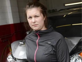 Erika Warren stands in front of the 2010 Honda minivan on May 28, 2014. The van which belongs to Warren's father caught fire while Erika and Janet were driving home after routine recall repair. (James Park/Ottawa Citizen)