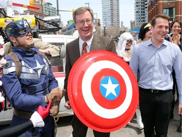 Everyone has a laugh as Mayor Jim Watson just misses bashing Councillor  Mathieu Fleury in the chops while trying out Captain America's shield as Ottawa Comiccon, which begins Friday at the EY Centre, held a press conference at Brother's Beer Bistro in the Byward Market. Photo taken on May 8, 2014.