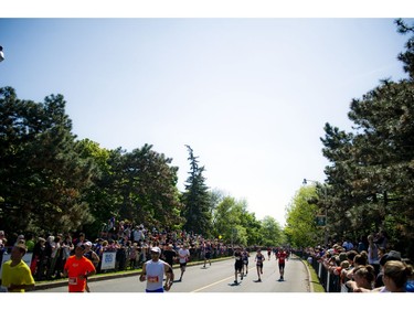 Fans and supporters line the race route to cheer on the runners during Ottawa Race Weekend Sunday May 25, 2014.