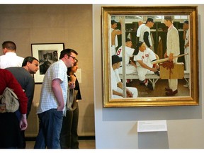 FILE - In this April 26, 2005 file photo, Norman Rockwell's "The Rookie" is displayed, at right, during an exhibit of "Rockwell and the Red Sox" at the Museum of Fine Arts in Boston. "The Rookie (Red Sox Locker Room)," appeared on the cover of the March 2, 1957, issue of the Saturday Evening Post. Christie's is offering it May 22, 2014, with a pre-sale estimate of $20 million to $30 million, which the auction house says represents that highest auction estimate ever for Rockwell.