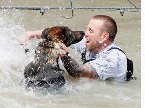 Forty police officers and their canine partners took part in the gruelling Iron Dog Competition Thursday at the Connaught Range and Primary Training Centre in Ottawa, May 1, 2014.  The four kilometre obstacle course involved swimming through small ravines together, navigating tunnels and climbing over walls.