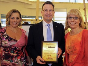From left, event chair Lia Rouleau, Star Motors of Ottawa GM Yves Laberge, with a plaque of appreciation, and Candlelighters executive director Jocelyn Lamont at the Spring Blooms fundraiser.