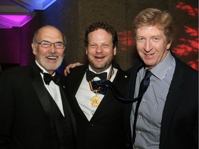 From left, Peter Herrndorf, president and CEO of the National Arts Centre, and NAC Award recipient Albert Schultz "tie one on" with actor R.H. Thomson on Saturday, May 10, 2014, at the Governor General's Performing Arts Awards Gala post-show reception.