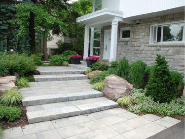 To keep a contemporary entrance in Alta Vista low-maintenance, Jason Smalley of Jason Smalley Landscape Design used hardy evergreens, small grasses, ground covers and large boulders.