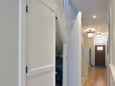 Embrace your space: Chuck Mills designed a walk-in pantry and storage cabinet to be hidden behind a panel detail and underneath an existing staircase.