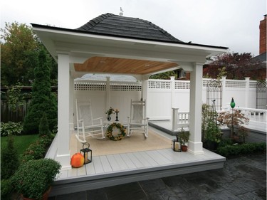 A gazebo with a bell-style roof structure completes the lower portion of a multi-level deck. A cedar ceiling with pot lights adds emphasis, while the structural components have been clad or trimmed in low-maintenance materials.