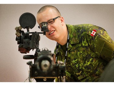 Gunner Alex Desouza checks the sights on a Browning 50 calibre M2 machine gun as the annual trade fair for military equipment known as CANSEC took place at the EY Centre near the airport.