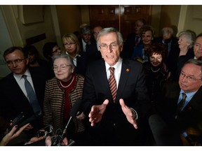 Sen. James Cowan, flanked by other newly declared Independent Senators, speaks to reporters on Parliament Hill on Jan. 29, 2014, following Liberal leader Justin Trudeau's announcement he was removing senators from the caucus.
