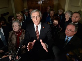 Sen. James Cowan, flanked by Sen Joan Fraser (left) and Sen. Jim Munson (right) along with the rest of the Senate Liberal group.