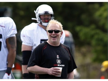 Jeff Hunt, president of OSEG (the owners of the Redblacks franchise) laughs with players at the CFL Ottawa Redblacks rookie camp at Keith Harris Stadium in Ottawa on Friday May 30, 2014.