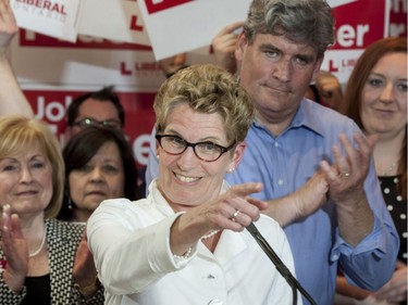 Ontario Liberal leader Kathleen Wynne gestures during a campaign stop in Ottawa South, the riding of John Fraser (right) and former riding of Premier Dalton McGuinty, in Ottawa on Wednesday, May 7, 2014. Ontarians go to the polls for a provincial election on June 12, 2014.