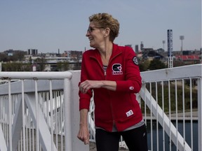 Ontario' Premier and Liberal Leader Kathleen Wynne walks through Toronto's Ontario Place as she makes her way to greet the press on Monday, May 19, 2014, as she continues her election campaign.