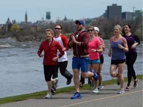 Ontario Premier Kathleen Wynne leads a group of runners along the Ottawa River during an election stop in Ottawa on Thursday, May 8, 2014. Ontario voters go to the polls on June 12th.