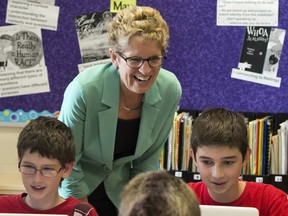 Ontario Liberal leader Kathleen Wynne checks in on students during a visit to Holy Cross school in Sault Ste. Maire, Ontario during a campaign stop on Tuesday May 20, 2014, 2014. THE CANADIAN PRESS/Frank Gunn