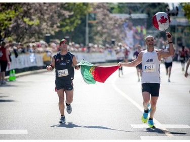 L-R Manuel Cabral and Joao Fernandes finish the marathon at Ottawa Race Weekend Sunday May 25, 2014.