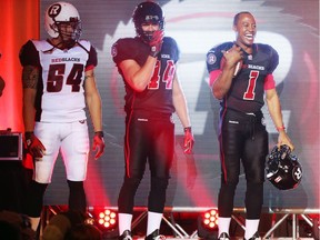 From left: Kevin Scott, Justin Phillips and Henry Burris of the Ottawa Redblacks of the CFL unveil their uniform, May 06, 2014.