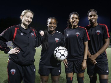 (L to R) The Ottawa Fury FC women's soccer team assistant coach Robin Rushton poses for a photo with Fury players Bryanna McCarthy, Ashley Lawrence and Kadeisha Buchanan at Algonquin College in Ottawa on Thursday May 22, 2014. They all played or still play for the same university team, West Virginia Mountaineers. (Patrick Doyle / Ottawa Citizen)  ORG XMIT: 0524 Fury03