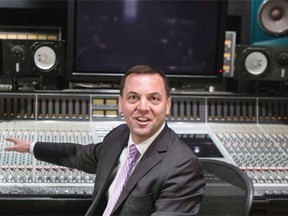 PC Leader Tim Hudak talks to the media as he sits at a mixing desk at Metalworks Studios, as he hits the campaign trail in Ontario's Provincial election in Mississauga on Monday May 5 , 2014. THE CANADIAN PRESS/Chris Young