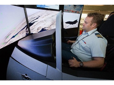 Major Donald Couzens checks out the F35 cockpit simulator as the annual trade fair for military equipment known as CANSEC took place at the EY Centre near the airport.