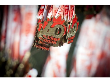 Marathon medals hang along the fence ready to be handed out to runners at Ottawa Race Weekend Sunday May 25, 2014.