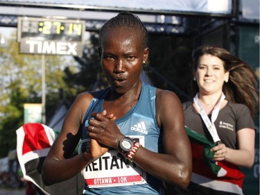 Mary Keitany, the top woman finisher, celebrates after crossing the finish line at the 10k race during the Ottawa Race Weekend on Saturday May 24, 2014. Her time was 31:21. (Patrick Doyle / Ottawa Citizen)  ORG XMIT: 0526 ottawa10k27