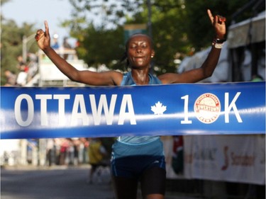 Mary Keitany, the top woman finisher, crosses the finish line at the 10k race during the Ottawa Race Weekend on Saturday May 24, 2014. (Patrick Doyle / Ottawa Citizen)  ORG XMIT: 0526 ottawa10k25