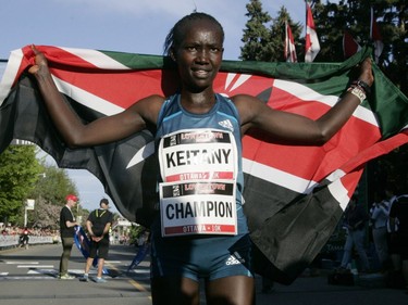 Mary Keitany, the top woman finisher, holds up the Kenyan flag after the 10k race during the Ottawa Race Weekend on Saturday May 24, 2014. (Patrick Doyle / Ottawa Citizen)  ORG XMIT: 0526 ottawa10k24