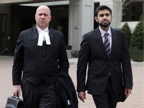 Misbahuddin Ahmed, right, leaves the Elgin Street courthouse with lawyer Mark Ertel after the completion of jury selection in Ottawa, Monday, May 12, 2014. Ahmed was arrested in August 2010 on terrorism charges.