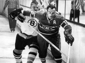 A March 1967 file photo of of Bobby Orr checking Henri Richard  at the Montreal Forum