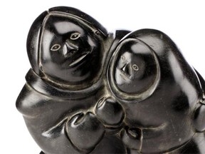 Lot 274: Mother and Child, by Mathew Aqigaaq, c. 1980, black stone. Est. $3,500 to $5,000. (Photo courtesy Walker Auctions)