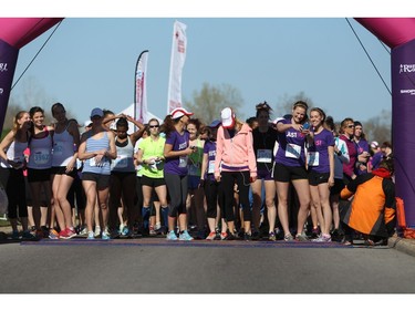 Mothers, daughters, and other family and friends wait at the starting line prior to the Shoppers Drug Mart Run for Women on Sunday, May 11, 2014 near the Aviation Museum. The 5K. 10K, and 1k for children helps raise money for Women's Mental Health programs in race cities, such as Royal Ottawa.