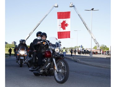 Motorcyclists ride in the Ottawa TELUS Motorcycle Ride for Dad at the Canadian Aviation and Space Museum on Saturday May 31, 2014.