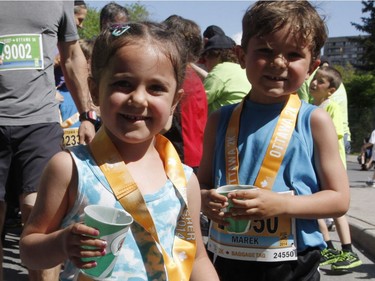 Nahla Jolliet (L), 4, and her brother Marek Jolliet, 6, receive their medals after the 2k run during the Ottawa Race Weekend on Saturday May 24, 2014. (Patrick Doyle / Ottawa Citizen)  ORG XMIT: 0526 ottawa10k08