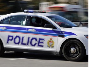 OTTAWA, ON: OCTOBER 2, 2013 - Lights and siren on, an Ottawa police cruiser vehicle races to a call in Ottawa on Wednesday, October 2, 2013.. (photo by Mike Carroccetto / Ottawa Citizen)???(for WEB / CITY story by ??) NEG# 114648