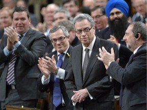 Finance Minister Joe Oliver receives applause during Question Period in the House of Commons on Parliament Hill in Ottawa, Monday, March 24, 2014 .