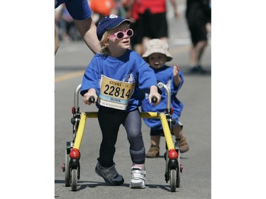 Olivia Schuler (L), 2 and half years old, and Brendan Varga, 14 months, participate in the 2k run during the Ottawa Race Weekend on Saturday May 24, 2014.