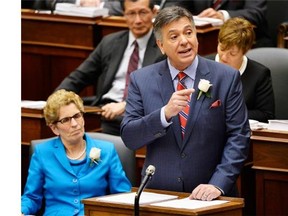 Ontario Finance Minister Charles Sousa, right, delivers the 2014 budget next to Premier Kathleen Wynne at Queen's Park in Toronto on Thursday, May 1, 2014.THE CANADIAN PRESS/Nathan Denette