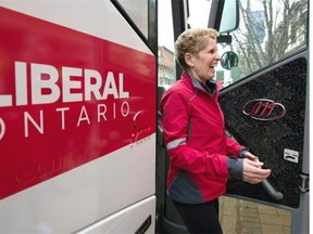 Ontario Premier Kathleen Wynne smiles as she gets off her bus at a campaign event in Milton, Ontario on Monday May 5, 2014.
