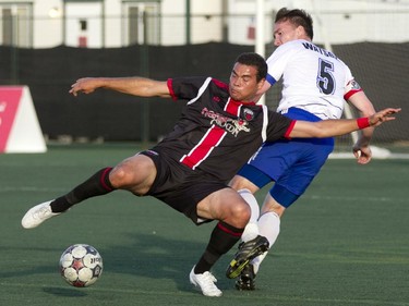 Ottawa Fury forward Vini Messoudi (left) battles for the ball against Edmonton FC's Albert Watson (right) during the teams match-up at Keith Harris Stadium in Ottawa, May 31, 2014.