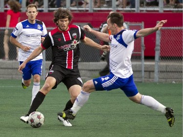 Ottawa Fury striker Tom Heinemann (centre) battles for the ball during the teams match-up at Keith Harris Stadium in Ottawa, May 31, 2014.